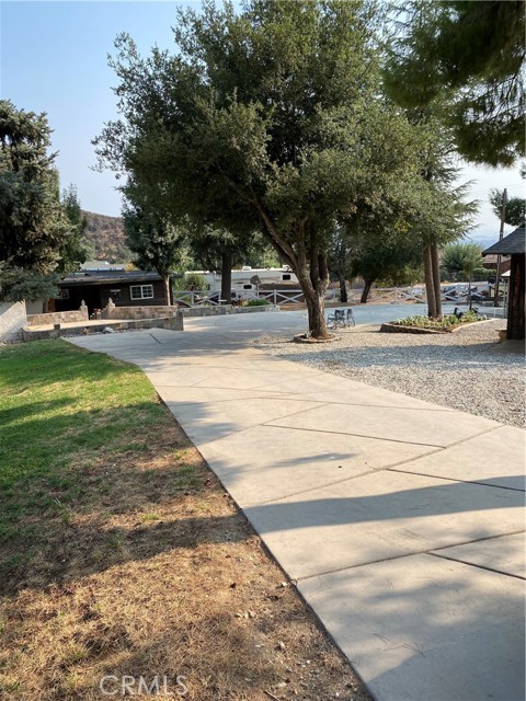 40275 Avenida Cerrovista Cherry Valley, California Simply beautiful location for this gem. The home sits at the rear of the corner lot, with drive access on two sides, making the majority of the property usable. Recently remodeled, the interior is open, fresh and tastefully decorated. The gourmet kitchen affords space for everyone & everything. There are two counter seating areas, a very large island with a stainless farmhouse sink, granite counters, new appliances, and includes a wine refrigerator. Relax in the inviting living room with a cozy fire in the wood burning stove complete with a custom mantel.
The master bedroom has access to the exterior as does the front bedroom. Boasting a split floor plan, the master and second bedroom are on one end and the front bedroom is on the other, which could be the perfect guest room.
Being outdoors at this property means enjoying large shade trees, having a place to keep your RV(s), toys and more. The three stall barn has plenty of room for tack and storage, the breezeway is concrete with drains and there is an additional concrete pad on the north side of the barn for the horse trailer etc. The area is great for horseback riding, hiking or just relaxing. This listing includes two parcels to total the 25700 sq.ft. lot size.
