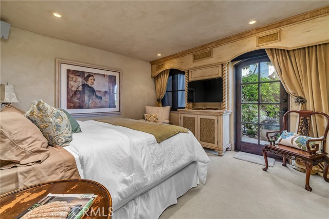 Downstairs bedroom exists to charming private patio.