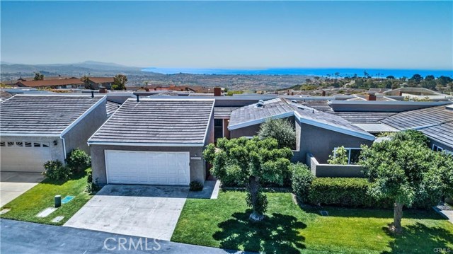 A SINGLE LEVEL 2 BR, 2 BA home in the heart of Laguna Niguel and overlooking the Pacific O cean, encourages the indoor/outdoor lifestyle Southern California is so famous for! This aerial view shows the proximity to the ocean and the sweeping coastline looking south towards San Diego and further. Large driveway and 2 car attached garage included!
