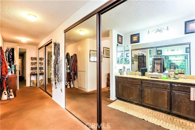 The Master Suite has a Tremendous Amount of Closet Space and a Wall of Mirrored Sliders as well as Storage Cabinets.  The Double Sink Vanity and the Dressing Area are Reflected in the Mirrors