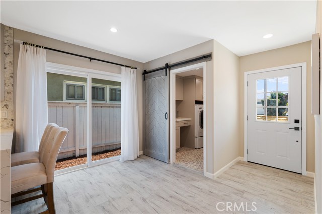 Entry and laundry room with barn door.