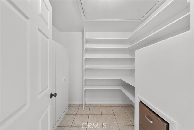 Extra Hall Storage Closet with built in shelving, cabinet storage, file cabinet, and safe.