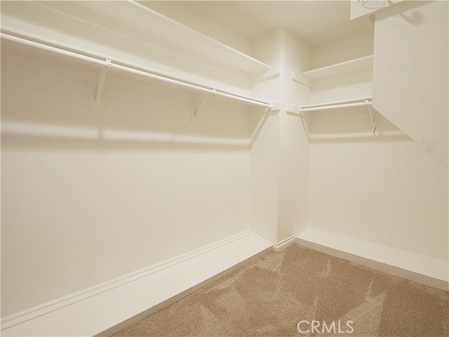 The larger walk-in closet in primary bedroom