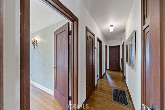 Hallway with double closets and cabinets.