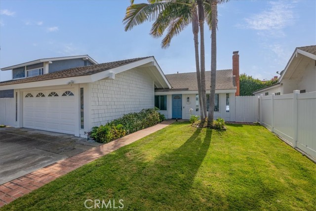 Front of Home with lawn and palm trees