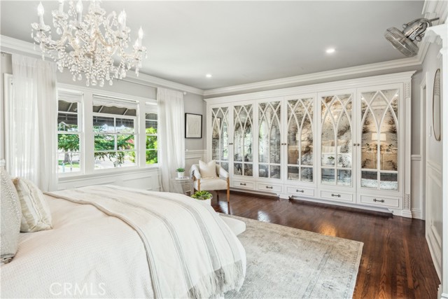 Romantic primary with chandelier and beautiful mirrored closets.