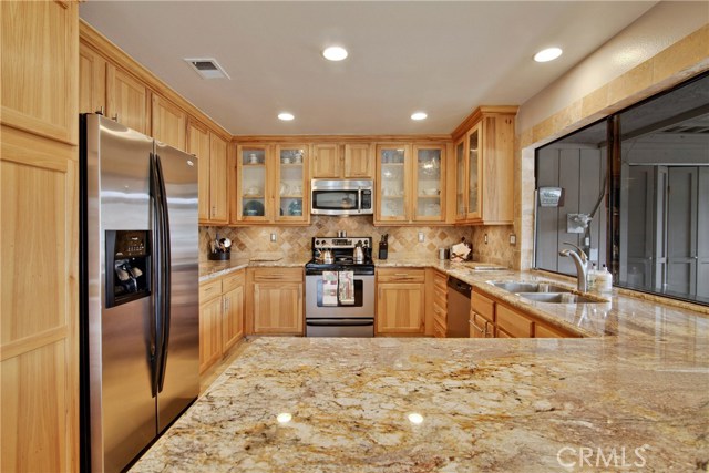 Remodeled kitchen with hickory cabinets, pull-outs, stainless appliances and granite counters.