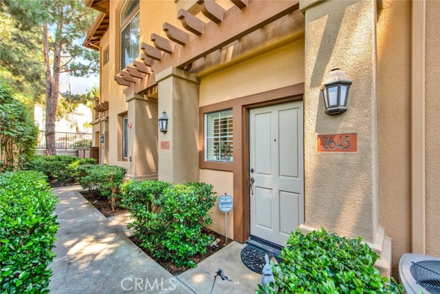 Welcome to 2645 Dietrich Drive, a highly coveted corner unit located in the prestigious Cantada Community of Tustin Ranch. This private townhome features two bedrooms, two bathrooms and an open floor plan that boasts soaring high ceilings and plenty of natural light throughout. The family room, complete with a cozy fireplace, plantation shutters, and a ceiling fan, opens to the dining area which has sliding door access to the balcony. The light and bright kitchen includes quartz countertops, a 4-burner gas range stove, recessed and under-cabinet lighting, and ample counter and cabinet space. The upstairs landing serves as an office space. The private master suite includes mirrored closet doors, built-in storage cabinets, and a remodeled en-suite bath with gorgeous travertine floors, dual vanities, and a walk-in shower. The private balcony enjoys tranquil views of the surrounding mature trees. Additional features include an indoor laundry room with cabinets and direct access to a single-car garage with built-in cabinets. The community boasts a resort-style pool and spa plus a barbecue area. HOA includes trash. Walk to Peters Canyon Elementary School and Pioneer Middle School, as well as nearby hiking and biking trails at Peters Canyon Regional Park, Irvine Regional Park and Citrus Grove Park. Walk to Pioneer Park and enjoy a summer splash pad, basketball court, covered pic-nic seating, large grass area and playground. Enjoy shopping and dining at the Tustin/Irvine Marketplace and a Short Drive to Tustin Ranch Golf Course, John Wayne Airport, and easy access to the 241/261 Toll Roads and 5/55/405 freeways. Don’t miss out on 2645 Dietrich Drive!