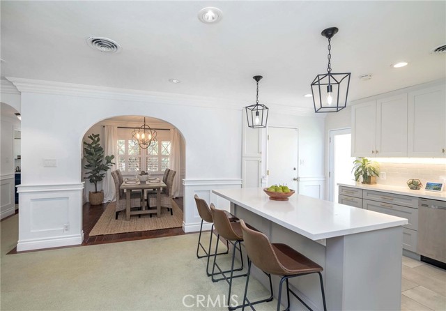 In modernizing this home, the owners kept a bit of the craftsmanship with the arches and wainscoting but brought in modern lighting and accents... it blends amazingly well!