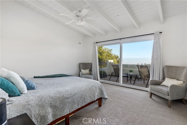 Big views from primary suite with doors to deck.