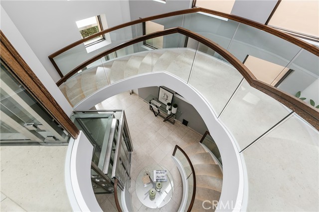 Circular  Stone Staircase with glass elevator