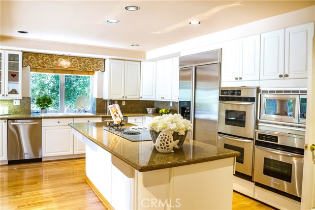 There are 3 ovens in this large chefs kitchen and all stainless appliances.