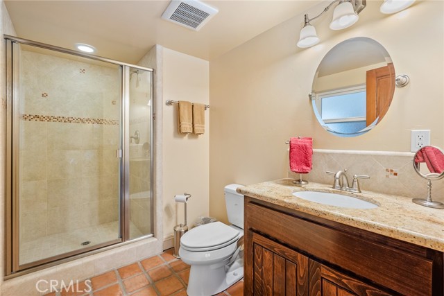 There's a 3/4 bath downstairs with striking shower and granite countertop vanity.