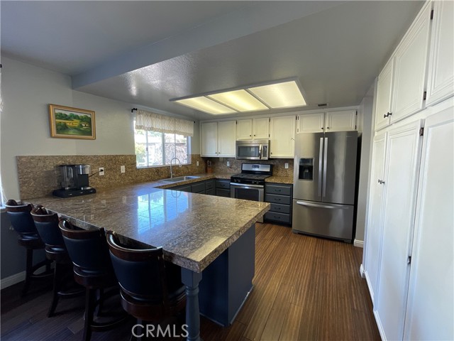 Granite tile counters offer a breakfast bar and plenty of workspace.