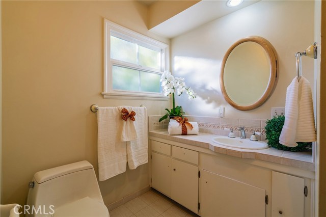 Hallway bathroom with tub and shower.