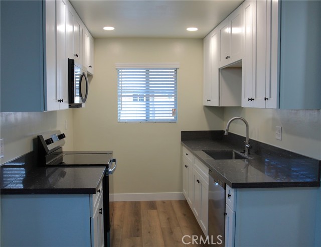 Kitchen with microwave and stove-photo with lights on