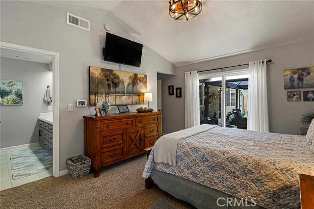 Vaulted ceilings, updated fan fixture, primary ensuite and slider access to backyard!
