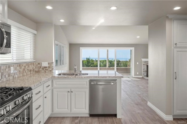 With a view like this, doing the dishes doesn't seem like such a chore. The kitchen flows openly into the dining and living rooms for ease of entertaining and dining al fresco.
