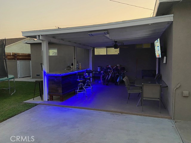 Backyard patio with outdoor bar - evening