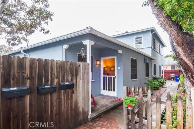 Front unit has a nice covered entry and gated walkway. Behind the mailboxes is a nice brick patio. You can also see the back lower unit and the upper unit. All 3 units are appx 700' each and SUNNY!