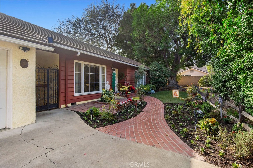 Welcome to 11252 Chapman Ave, a rare and extraordinary find in the heart of Garden Grove! This 3-bedroom, 3-bathroom home offers a generous 2,987 sq. ft. of living space, situated on an expansive lot of over 1.1 acres (48,900 sq. ft.). The backyard boasts a sparkling pool, perfect for entertaining or relaxing, while the front yard features a charming red brick pathway, inviting you into this unique property. The property’s incredible size presents endless opportunities—whether you’re dreaming of creating a lush garden retreat, or exploring its development potential. Inside, you’ll find a bright and functional kitchen with granite countertops, ample cabinetry, and stainless steel appliances. The living spaces are warm and welcoming, showcasing stunning hardwood floors, exposed beams, and a brick-accented bar that’s perfect for gatherings. Nestled in a prime location, this property combines privacy, space, and potential with convenient access to shopping, dining, schools, and parks. Whether you are seeking a serene retreat or looking for exceptional investment possibilities, this home has it all! Don’t miss out on this rare opportunity to own over an acre of land in the heart of Garden Grove.