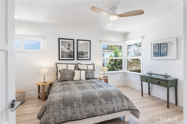 Spacious upper unit bedroom with beatufiful flooring, great windows, large closet, ceiling fan and recessed lights