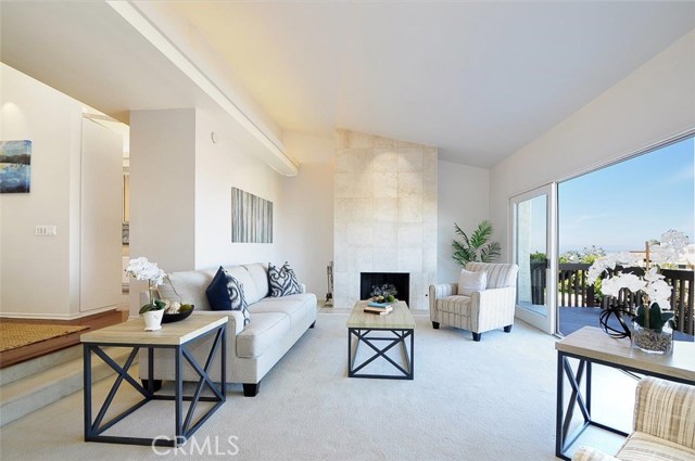 Step Down Living Room with Fireplace and View Balcony