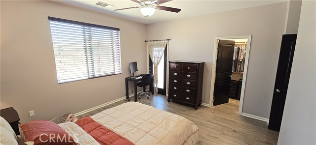 Primary bedroom. Walk in closet & door to back yard