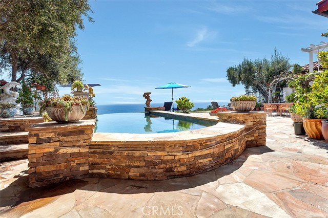 176 Sidney Bay Drive Newport Coast, California Ocean View! Ocean View. This spectacular home has unobstructed panoramic views of the ocean, including whitewater, Catalina Island, the coastline, and Crystal Cove state park. Situated approximately 300 feet above and 1000 feet distance from the ocean, with no rooftop or treetop, this front row property offers a stunning commanding view of the ocean, from Laguna Beach to Palos Verdes. No currently available rental property has this kind of view. There are 5 bedrooms including a ground floor master bedroom suite with a fireplace, 2 private guest quarters, and 5.5 bathrooms. Special features include custom built-ins, a gourmet kitchen, an attractive dining room that opens to a gorgeous courtyard, vaulted ceilings, custom cabinetry, finished closets, and designer light fixtures throughout. The front exterior highlights are courtyards, fountains, beautiful stonework, and Santa Barbara-inspired softscape. The rear garden offers an infinity pool/spa that blends into the ocean, surrounded by olive trees, hanging fuchsia, and succulents. This versatile floor plan has rarely been on the market. Located near the shopping center - with its assortment of great restaurants and shops. The new tenant will have access to the Canyon Club with its exercise rooms, party room, junior Olympic pool with spa, showers, lockers, and 3 lighted tennis courts.
