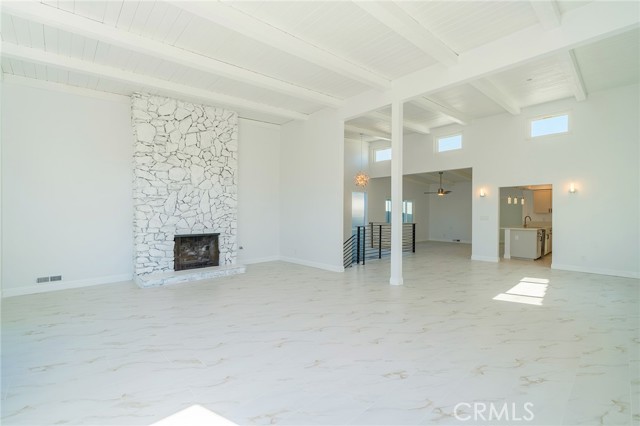 Living room with fireplace and clerestory windows above the kitchen, dining room and stairwell