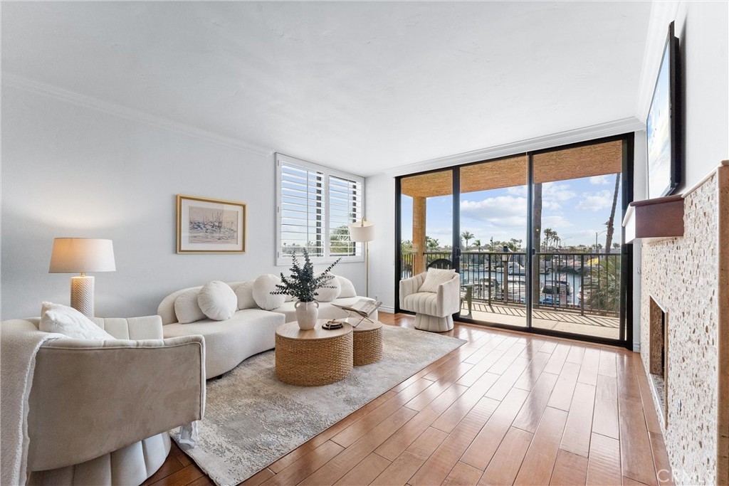 Stunningly Upgraded Two-Bedroom, Two-Bathroom Condo with Two Parking Spaces, Breathtaking Water Views, and In-Unit Laundry! Welcome to your peaceful coastal retreat nestled in the highly desirable Belmont Park neighborhood just off 2nd Street—this isn’t just a place to live...it’s a lifestyle of ease, beauty, and coastal charm.This beautifully renovated condo blends luxury with comfort and offers sweeping water views that create a truly tranquil setting. Step out onto your private balcony and take in the calming sights of sailboats gliding by, gentle ripples on the water, and the soft rhythm of coastal life. During the holidays, enjoy the charming glow of the iconic Trees in the Bay and the festive boat parade right from your front-row seat. Inside, no detail has been overlooked. From the exquisite four-inch crown molding to the stacked stone fireplace, elegant plantation shutters, and beautiful hardwood floors, every inch of this home exudes sophistication. The kitchen and bathrooms feature gorgeous granite countertops, and new dual-pane windows provide both beauty and energy efficiency. The spacious primary suite is a serene haven with oversized closets, a private en-suite bathroom, and peaceful views that make everyday living feel like a getaway. The generously sized second bedroom is ideal for guests or a home office. Additional upgrades include a built-in office space, a brand-new wine fridge, freshly painted interiors, new lighting fixtures throughout for a bright, welcoming feel, and an in-unit laundry area for added convenience. Two dedicated parking spaces add even more value to this exceptional home. Plenty of community amenities complete the picture: enjoy a sparkling pool, relaxing spa, and barbecue area perfect for gatherings or quiet evenings. Don’t miss the chance to make this stunning waterfront condo your own!