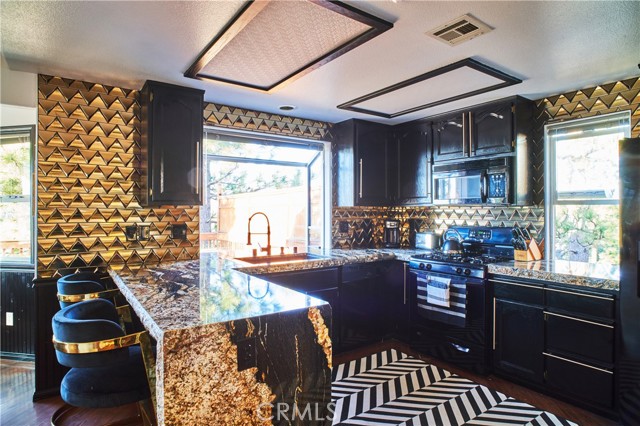 Remodeled kitchen with granite counters and waterfall