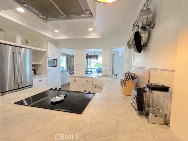 Kitchen complete with lit exhaust hood.