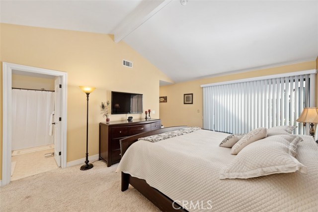 Master bedroom with high ceilings, sliding door, walk in closet and 3 mirrored door closet and storage.