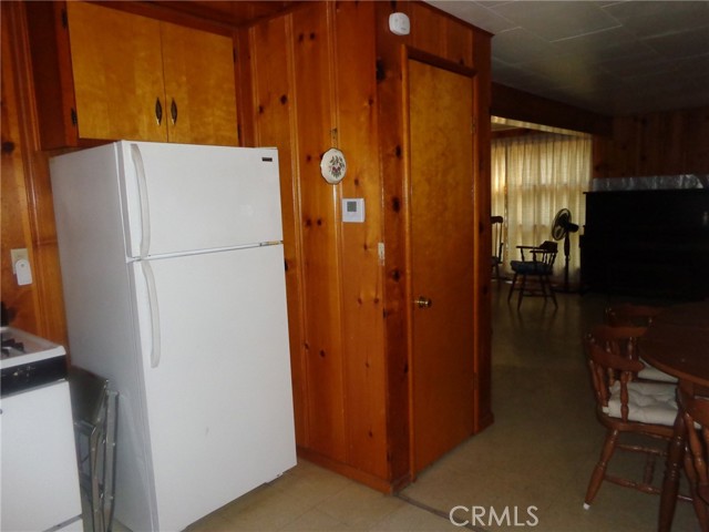 Refrigerator and storage closet in kitchen