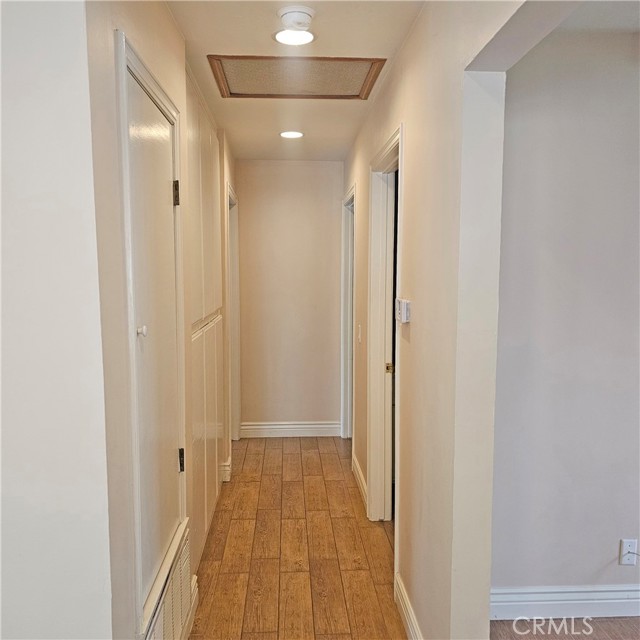 Hall way leading to 2 bedrooms and bathrooms