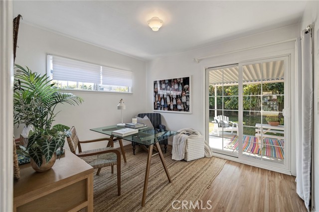 Sliding Doors open to the large, covered patio and grassy green yard.