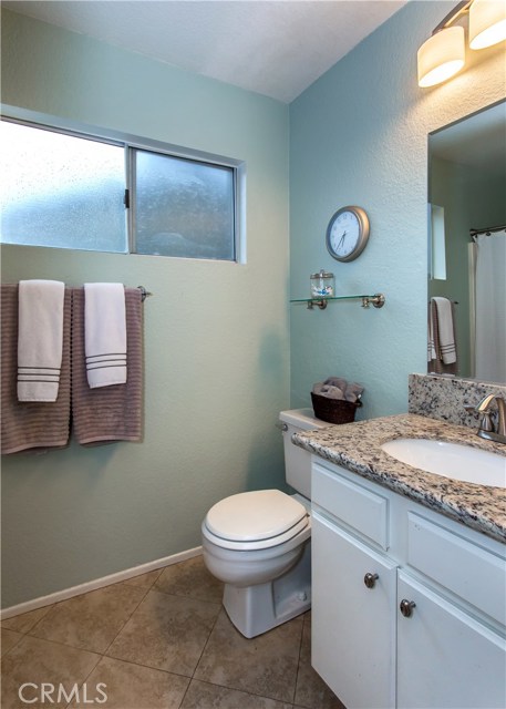 Remodeled second bathroom with granite countertops, ceramic tile floors, immaculate shower and tub & custom lighting.