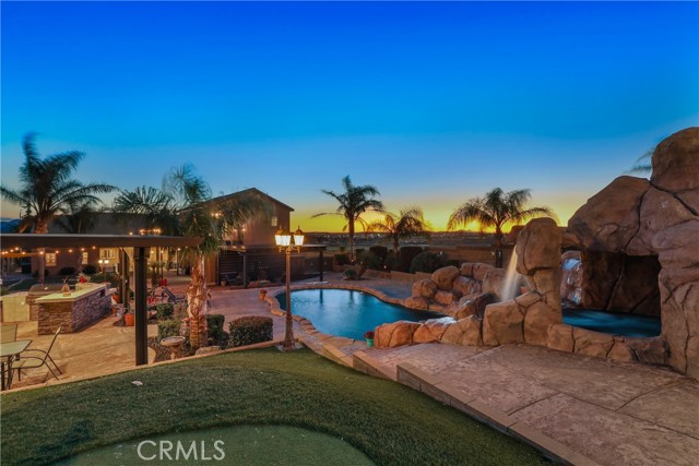 A true Entertainer's PARADISE! This home has it ALL and still conveniently located close to the 10 freeway and shopping! No need to ever leave home as your backyard is a tropical paradise: large pool, spa with grotto/cave with a waterfall above (2 waterfalls) and built in slide, FULL outdoor built-in kitchen, 2 large covered patio areas, one with a large gas fire pit, 5 hole putting green with sand pit for chipping, horseshoe pits, outdoor lighting literally everywhere, the list goes on! Need room for your toys or business 1500sqft+ Shop with its own entrance, 35' deep 42' wide RV garage with two 14' tall 16' wide doors! Once you walk into your 4,043sqft home you will be greeted with 15+ foot tall ceilings with custom home features throughout the entire home! 5 bedrooms, 5 bathrooms AND a full guesthouse/ mother in law suit above the garage (with its own entrance)! The master bedroom is one you don't want to miss with it's own private office/gym, built in fireplace and it's own entrance to your vacation backyard! Your dream has come true with this home! Can't forget we have a 3-car attached garage with pull through door to the backyard, perfect for when entertaining! The list goes on and on with this home, believe me when I say it's a MUST SEE in person!