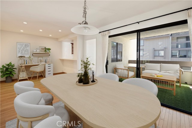 Dining room and den/office/flex space with connected covered patio and pass-through kitchen. Photo has been virtually staged.