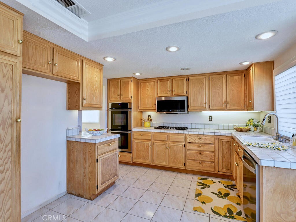 Double ovens, microwave, dishwasher and five burner gas stovetop