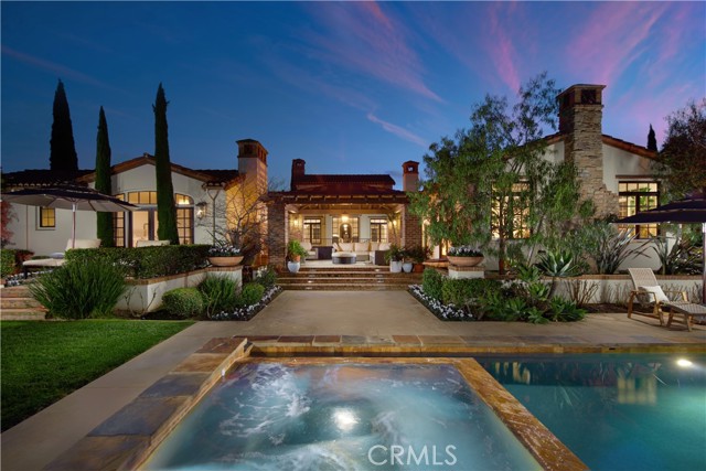 Your quest for the finest combination of custom architecture, enduring luxury, sublime privacy, and a prime location will come to fruition at this completely upgraded estate in San Juan Capistrano. Remodeled in 2020, the elegant Spanish Revival masterpiece is extra bright and welcoming, with five en-suite bedrooms and five full and four half baths showcased in approximately 8,685 square feet. Making a perfect first impression, the formal living room embraces style with an open-beam ceiling, featuring clerestory windows placed above the beams. Memorable entertaining can be enjoyed throughout the two-level home, which also features a great room with a fireplace, an open dining area, backyard access, and a phenomenal kitchen with an oversized island, butler’s pantry, wine fridge, white cabinetry with illuminated uppers, quartz countertops, a Shaws farmhouse sink, a built-in Sub-Zero refrigerator with a glass door, two Miele dishwashers, two Viking warming drawers, and an oven and microwave by Wolf. The estate is further enhanced by RV parking with hookups, EV chargers in both garages, a water filtration system throughout the house, and a central vacuum system. Centered around a private courtyard with a fireplace and fountain, the lower level is outstanding. Discover a home theater with a large screen, power recliners, and surround sound; a gym with a bath; a sauna, steam room, and massage area; a game room; a walk-in pub bar; a walk-in temperature-controlled wine room; and a TrueGolf golf simulator. An elevator and a staircase provide access to both levels, which are richly appointed with custom millwork, vaulted and coffered ceilings, multiple indoor and outdoor fireplaces, hardwood and stone flooring, patterned carpet, indoor/outdoor Sonos speakers, Nest-controlled HVAC, DoorBird video monitoring at gates, and numerous French doors. A lovely terrace and a balcony enrich the primary suite’s posh appointments, including an oversized multi-head walk-in shower, a freestanding tub, LED mirrors, and a walk-in closet with built-ins. Sprawling grounds feature a pool and spa, a full-featured outdoor kitchen, and a five-car garage.
