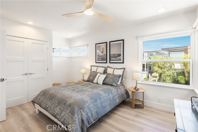 Spacious upper unit bedroom with beatufiful flooring, great windows, large closet, ceiling fan and recessed lights