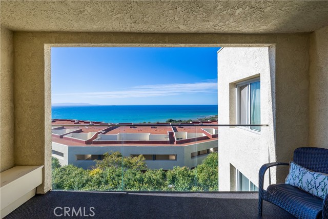 The spacious living room features a warm fireplace, wet bar, and opens to the large ocean view balcony that’s the perfect for everyday indoor-outdoor living, entertaining guests at sunset with the stunning view.