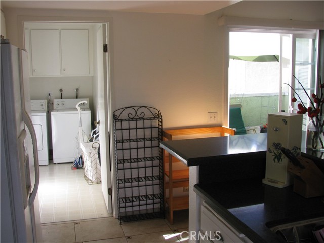 Separate Laundry Room with plenty of storage cabinets