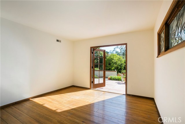 This bedroom features French doors to a private rear patio and the yard.