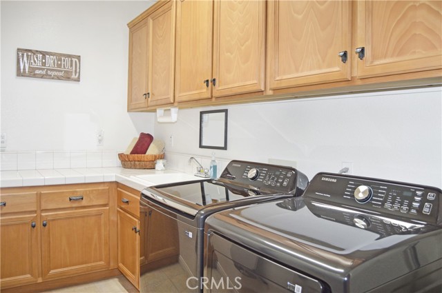 Laundry/Utility Room with BRAND NEW Washer & Dryer, Plenty of Cabinet/Counter Space and a Handy Sink