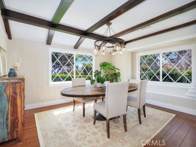 Formal dining room with wood beam ceilings.