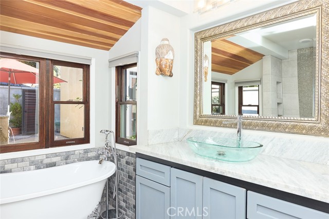 soaking tub embraced by
lush landscape and tranquil water feature sound.