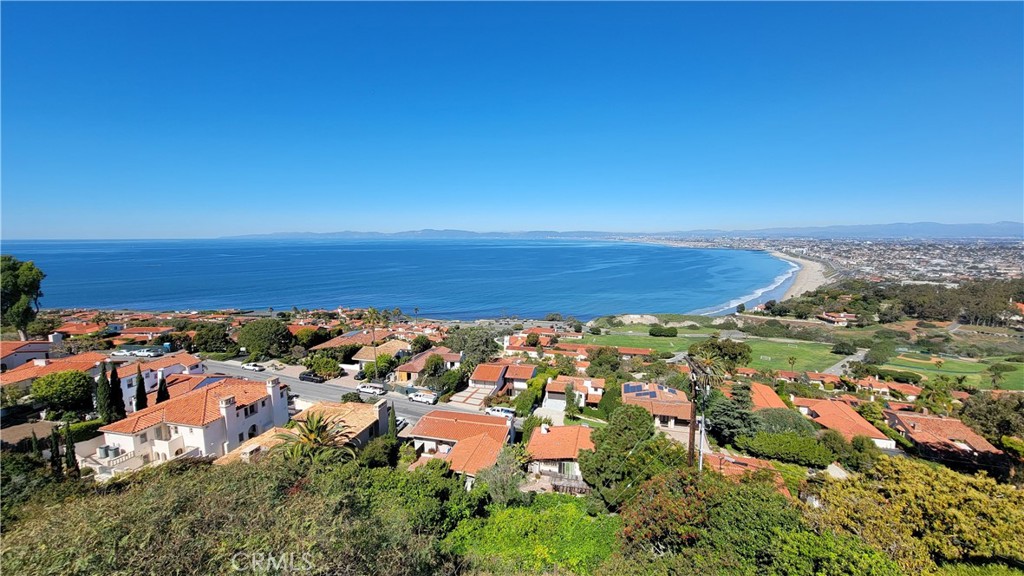 Take the 360 tour https://t.ly/kGvY ***Watch the video: https://youtu.be/ZvMrec7745M *** Expansive panoramic ocean and city views make this one-of-a-kind Mediterranean-inspired home in Upper Malaga Cove a must-see property. Conveniently located in western Palos Verdes Estates, this 3892 sqft home sits at the top of a sprawling quarter-acre lot, with breathtaking, unobstructed Queen’s Necklace views from top-to-bottom of the entire home and property. Each of the home’s three levels features a cozy fireplace and private wrap-around northwest-facing balcony. Almost 1500 sqft of total balcony space! The master suite, office, first laundry room, and two-car garage make up the top level. The stunning master suite features a stone fireplace with custom-etched glass, where you can wake up every morning to an awe-inspiring view that makes you feel on top of the world. The large master ensuite features double long vanities, built-in storage, walk-in closet, spa tub, and separate shower and toilet room. 

Heading to the main level, you’ll find the kitchen, formal dining room, guest bath, family room, living room, main-level wrap around deck, built-in outdoor grill, and of course, the beautiful pool! Three bedrooms - two of which boast more expansive ocean views - plus two full baths, a second laundry room with kitchenette, refrigerated wine cellar, and a second family room/den make up the lower level. The backyard features multiple tiers and spaces to create a serene and dynamic outdoor entertaining space. There you can gaze upon the same incredible LA basin and city views, while entertaining, playing, lounging, and recharging in the sun, in the pool, or on the “meditation deck” under a gorgeous tranquil tree! You'll enjoy the convenience of laundry rooms on both levels that feature bedrooms. And room for five total cars: two in the attached garage, two on the "bridge" and one in the off-street space.

With over 80 linear feet of ocean-facing glass sliding doors, every inch of this home celebrates Southern California and the quintessential twinkling coastline of the South Bay. Get settled in just in time to enjoy the perfect weather and gorgeous sunsets of the So Cal summer.

Conveniently located just 3 mins from Malaga Cove Plaza, 5 mins from the PV Beach Club, cliffs, and surf, and just 7 mins to the Redondo Beach Riviera and rest of the greater South Bay.